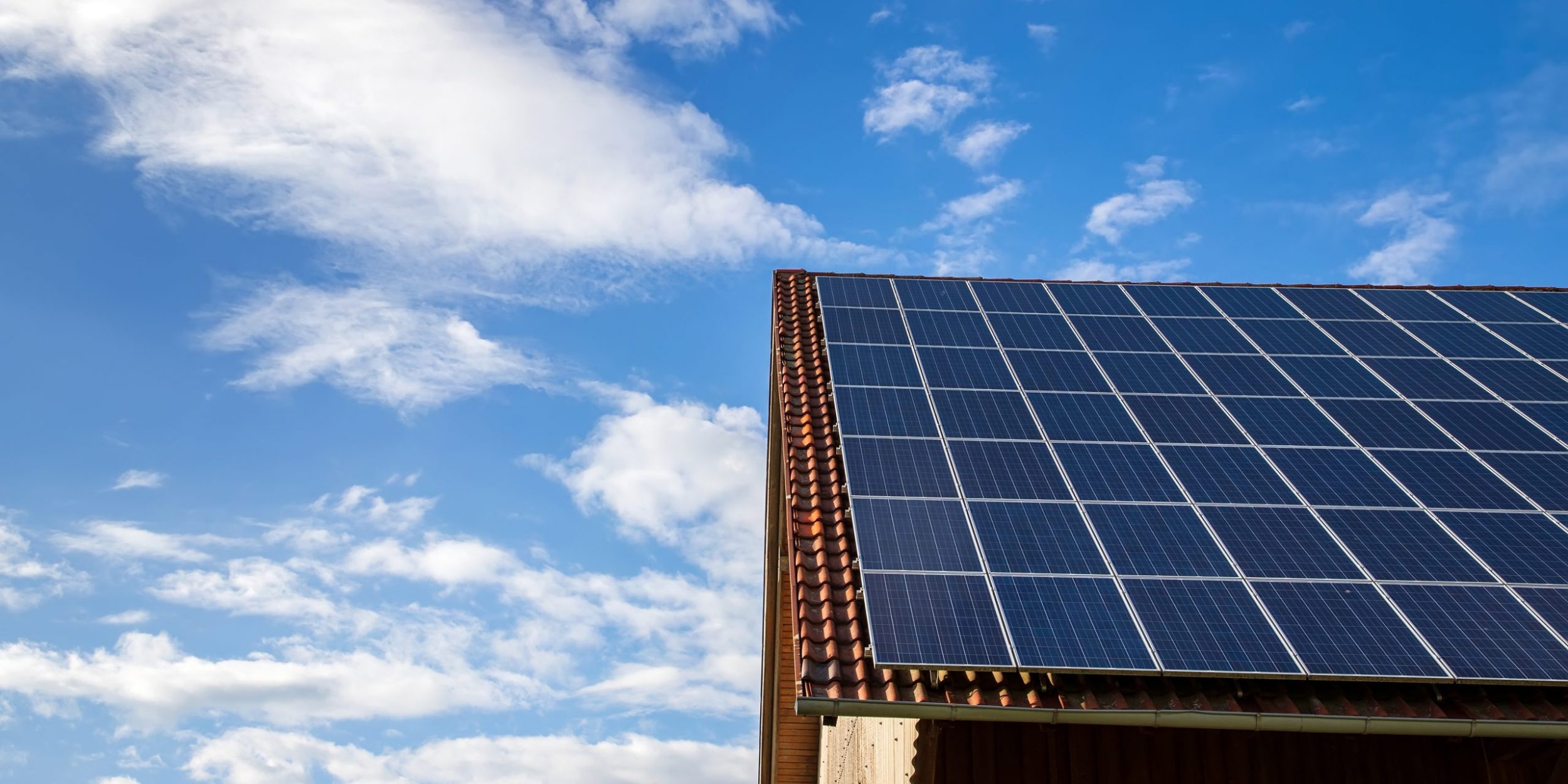 solar panels on the roof of a house. horizontal orientation, blue sky. Energy concept